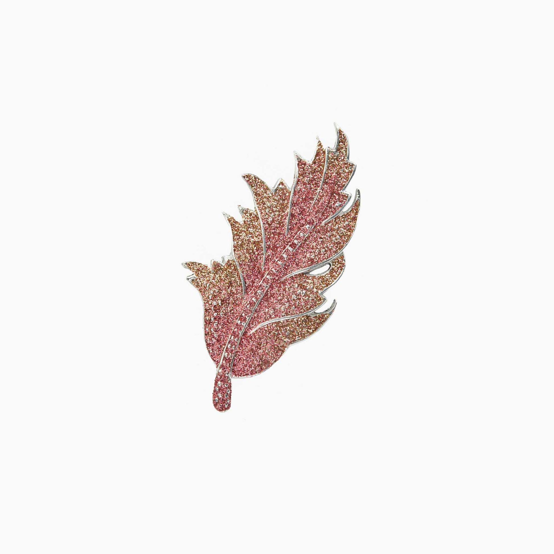 Decorative leaf-shaped brooch on a white background
