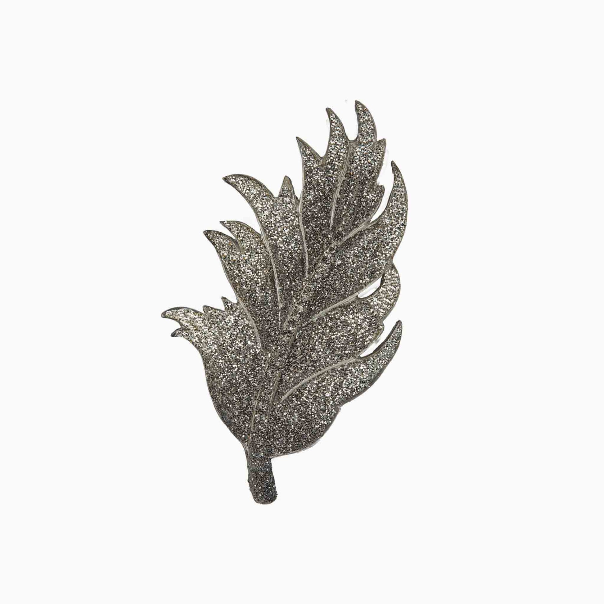 Decorative leaf-shaped brooch on a white background
