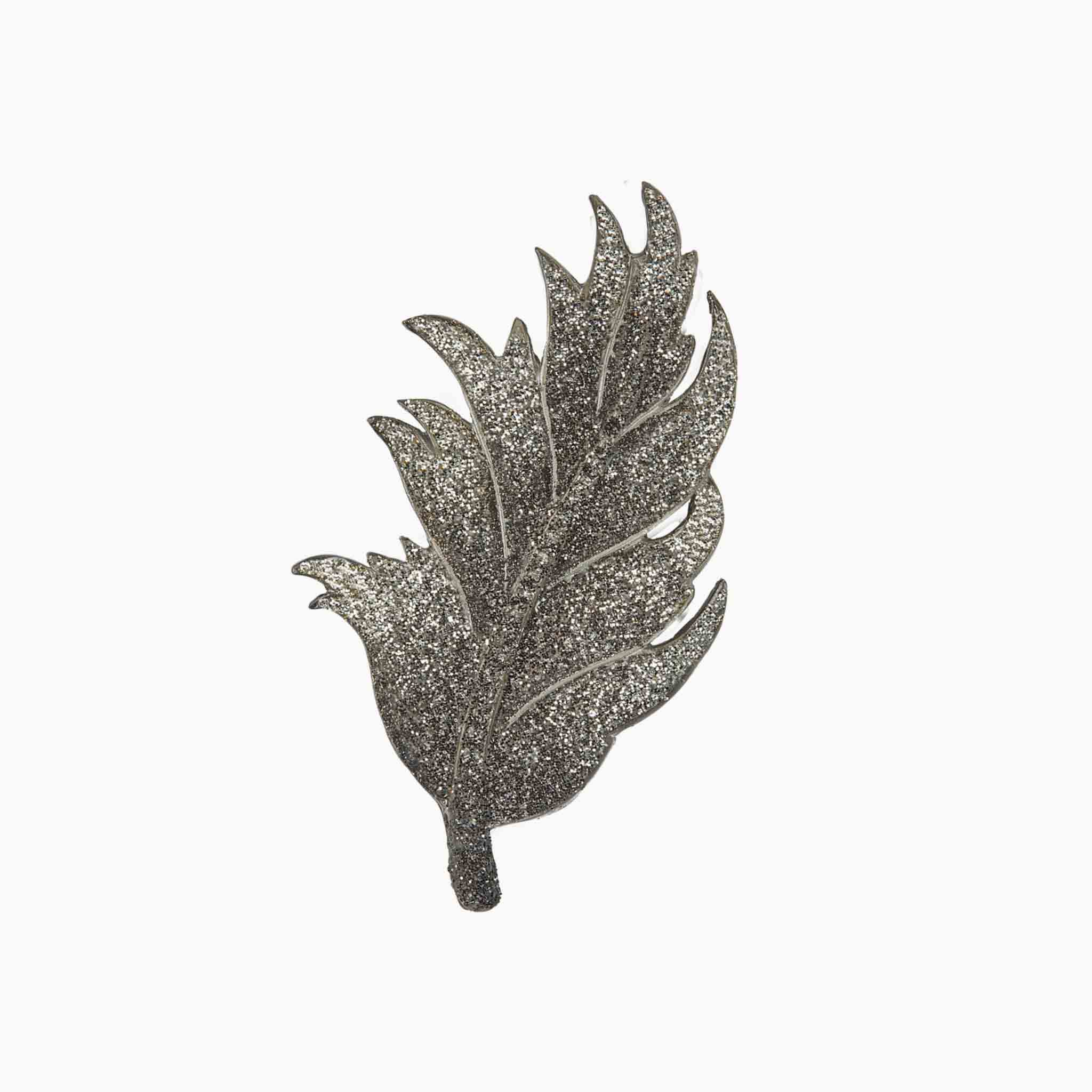 Decorative leaf-shaped brooch on a white background