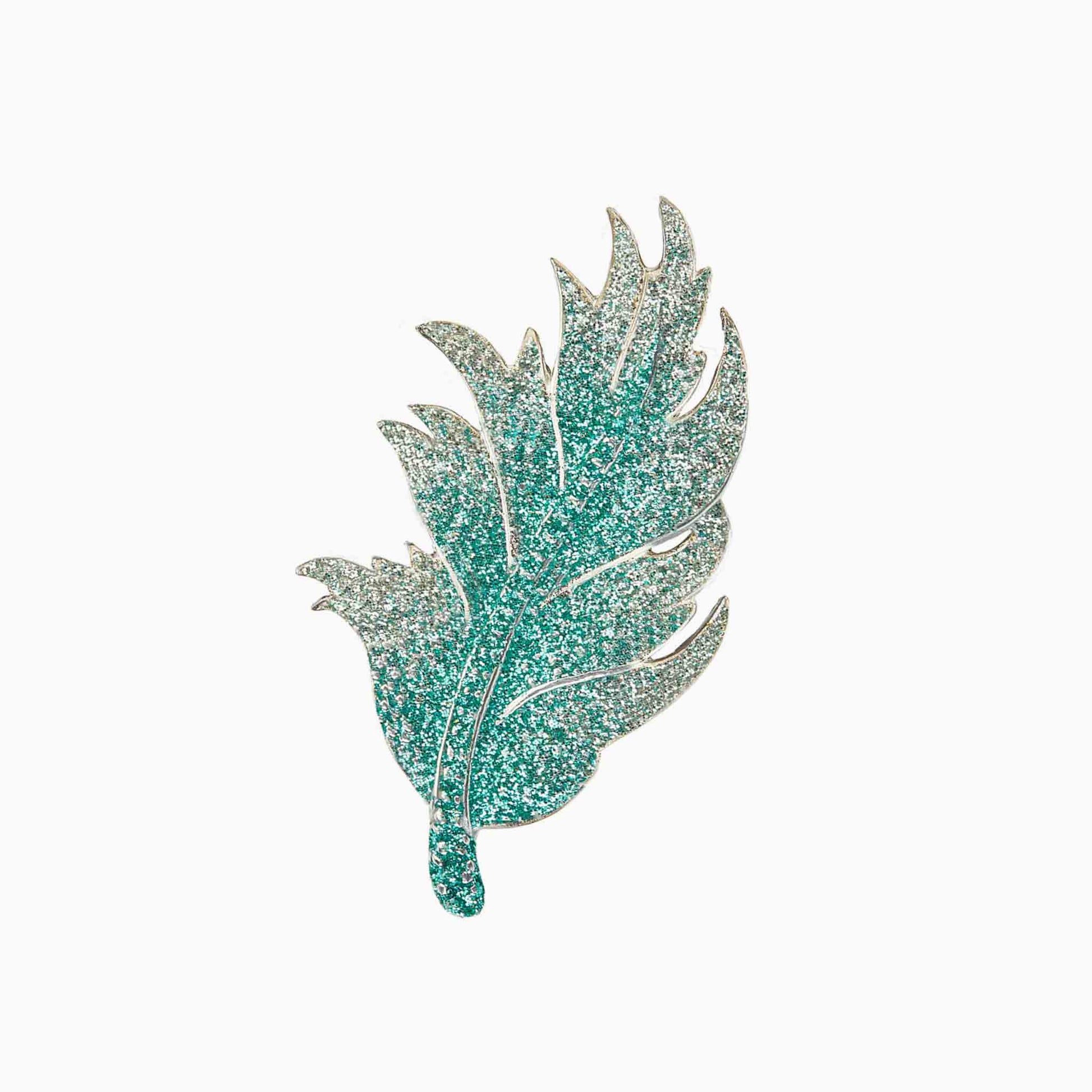 Decorative leaf-shaped brooch on a white background