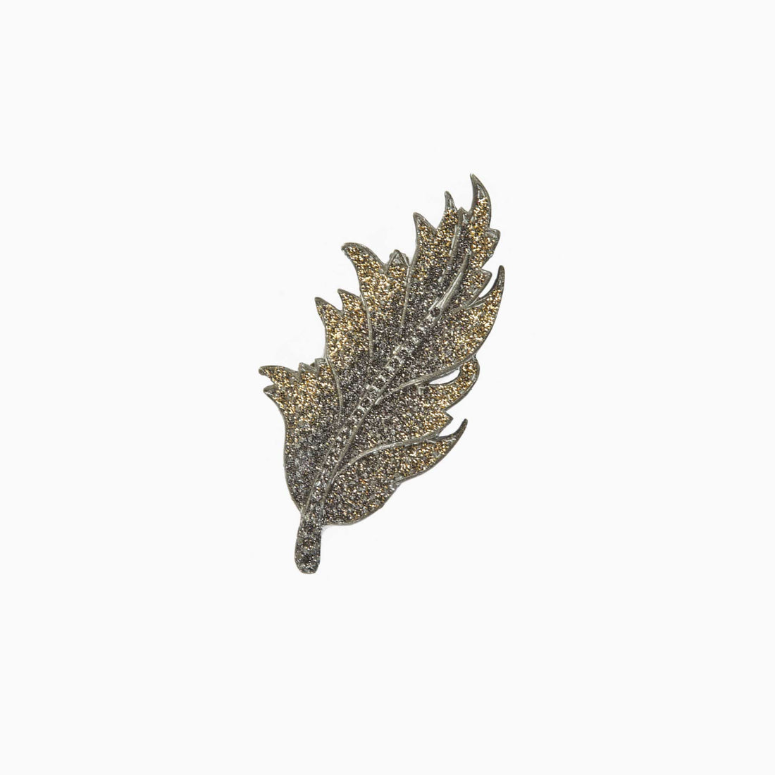 Decorative leaf-shaped brooch on a white background