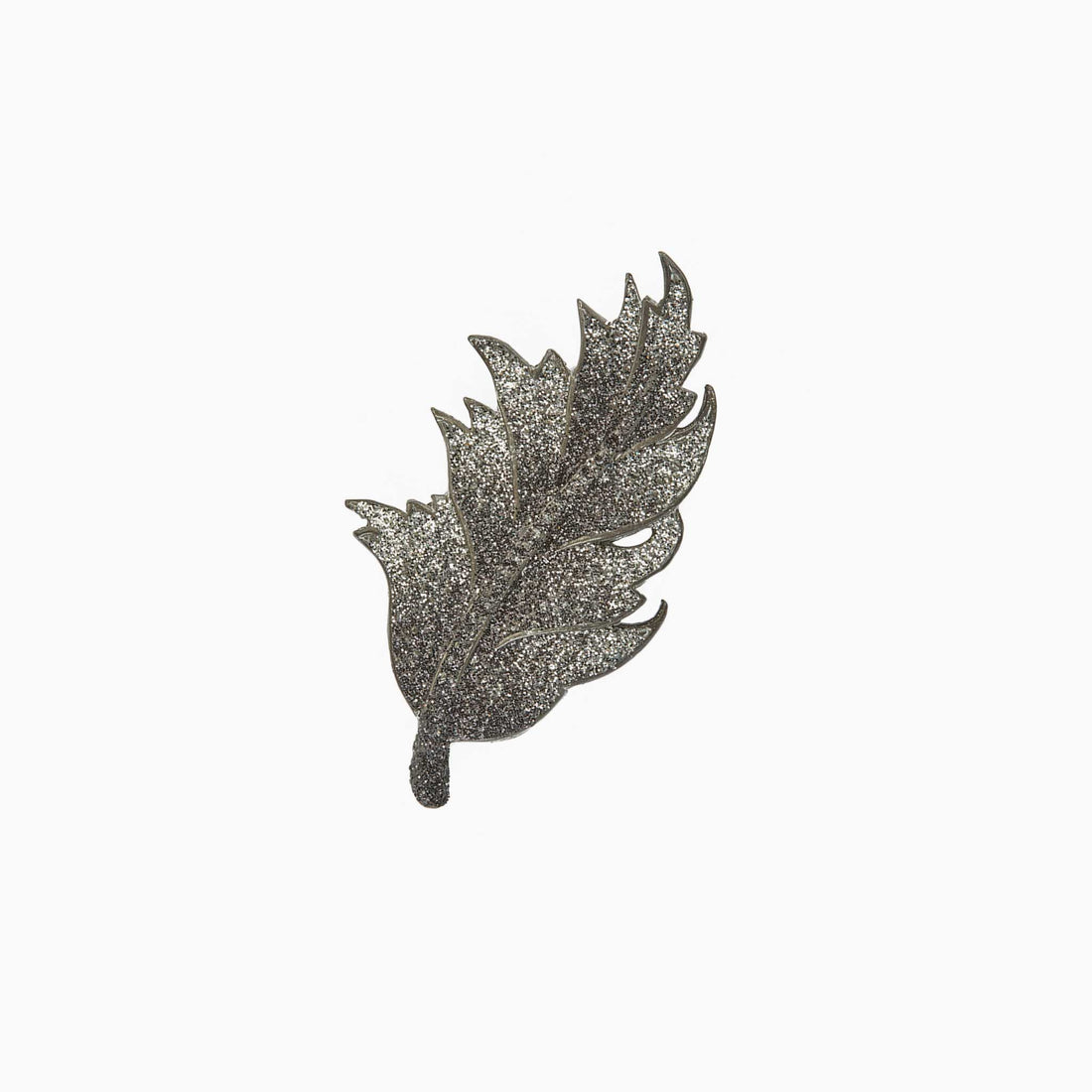 Decorative leaf-shaped brooch on a white background