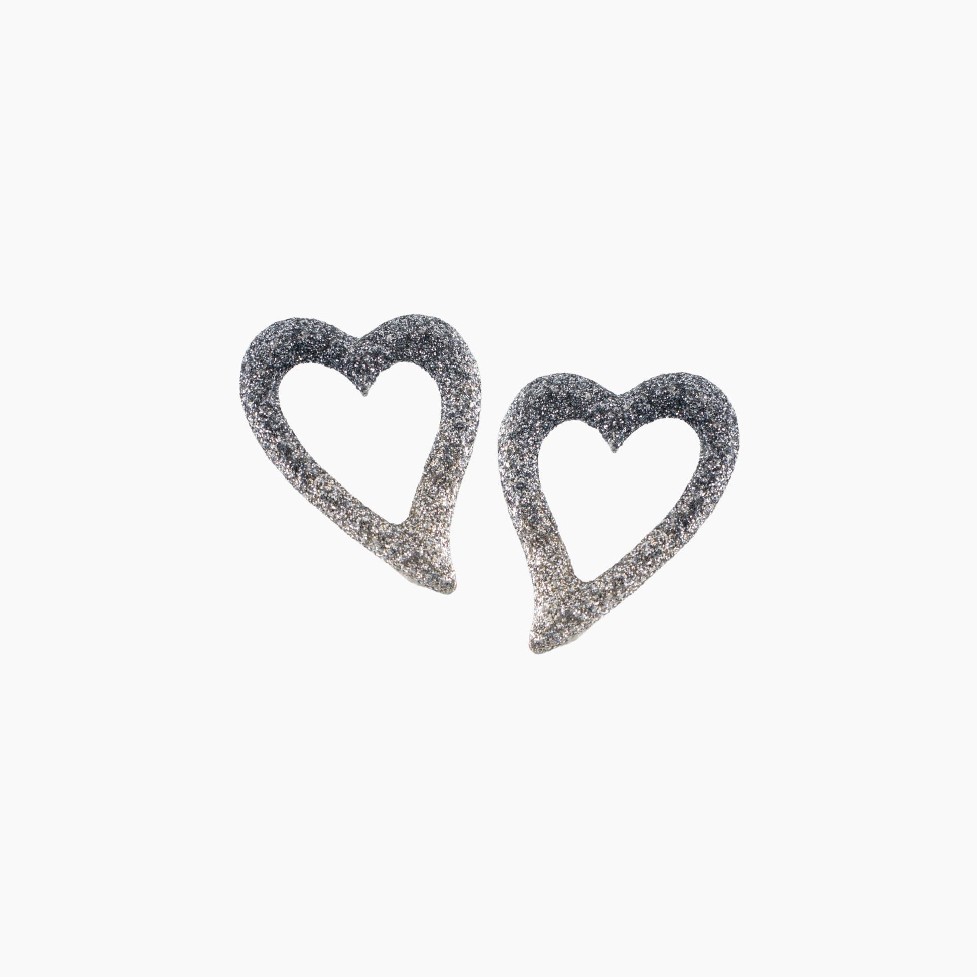 Heart-shaped earrings with glittery finish on a white background