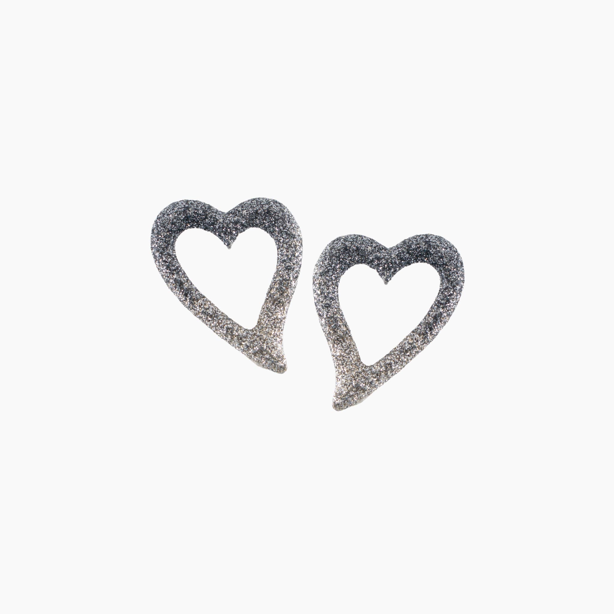 Heart-shaped earrings with glittery finish on a white background