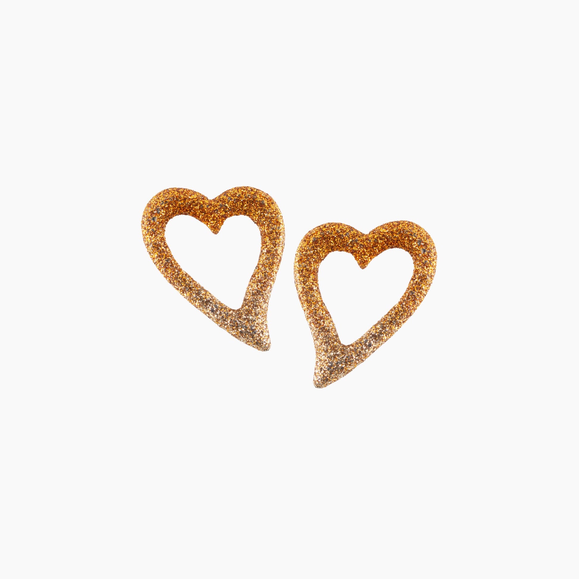 Heart-shaped earrings with glittery texture on a white background