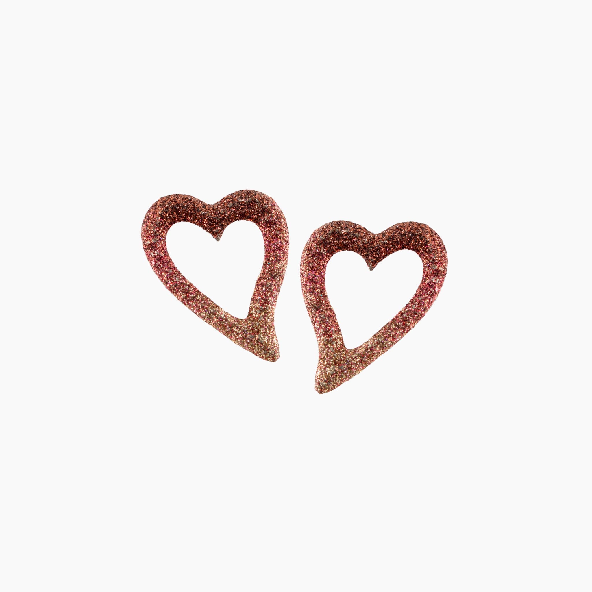 Pair of heart-shaped earrings with glittery texture on a white background