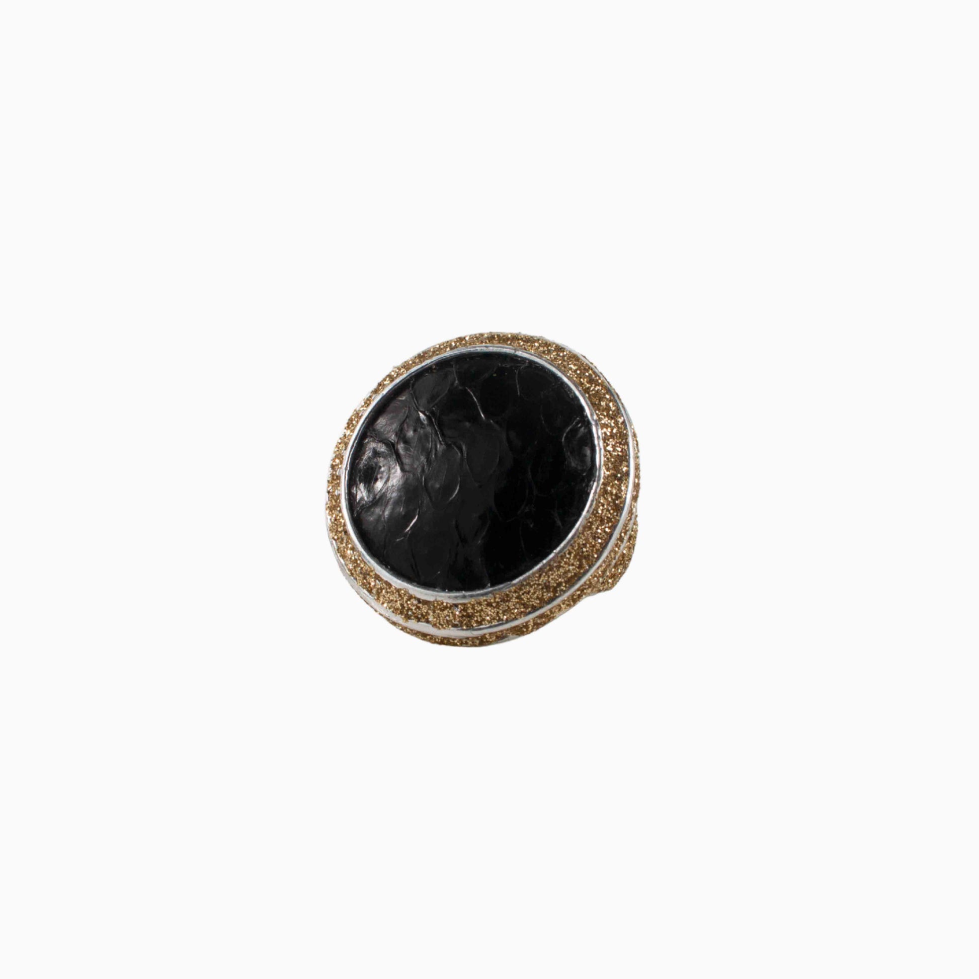 Decorative ring with black stone and gold accents on a white background