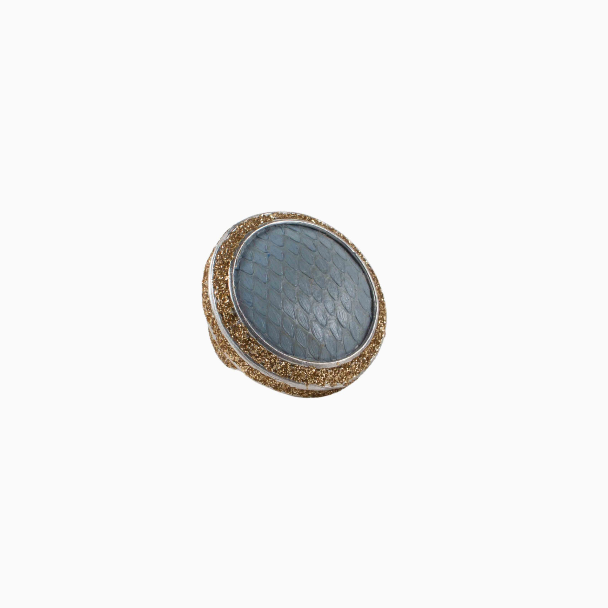 Round decorative item with textured surface and gold rim on a white background