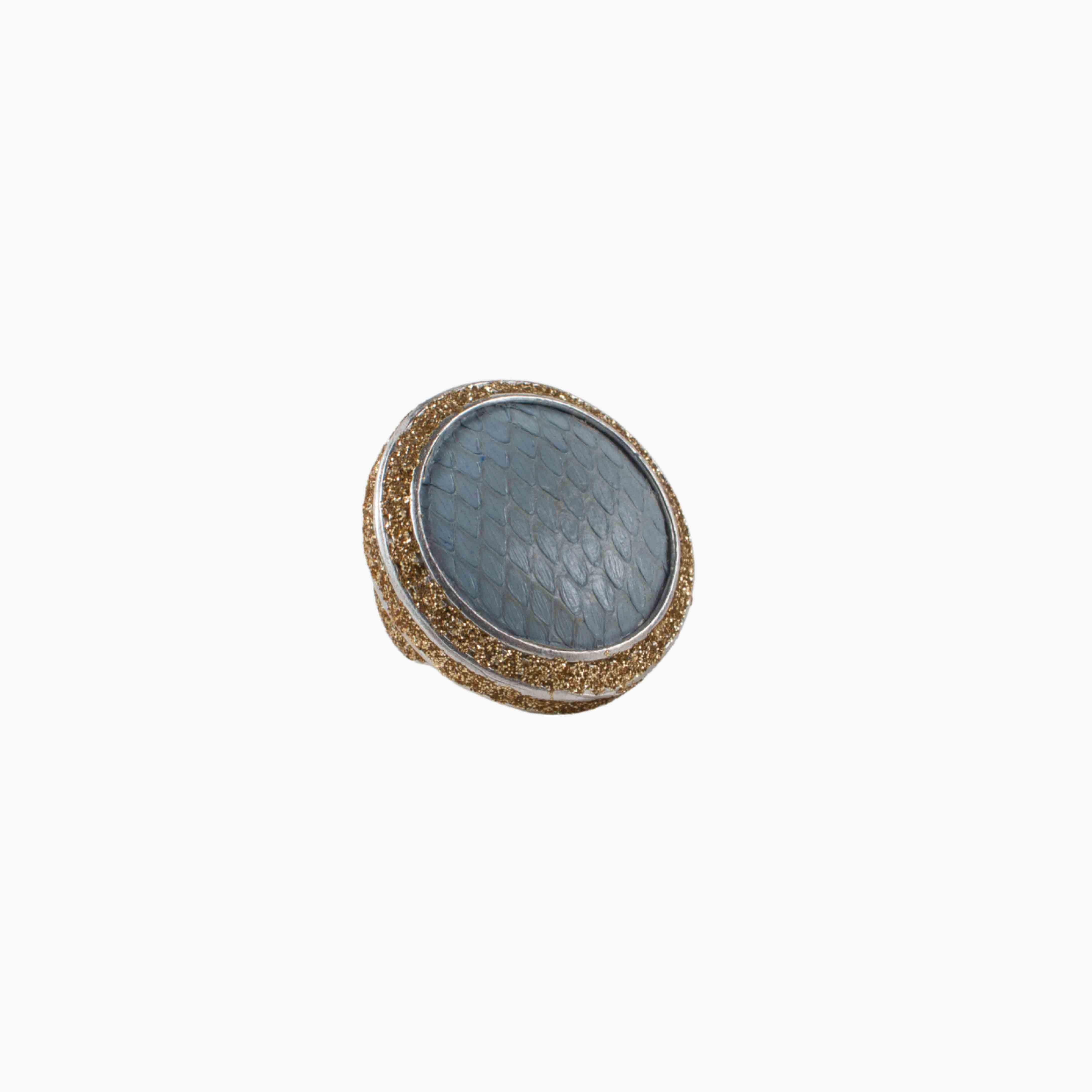 Round decorative item with textured surface and gold rim on a white background
