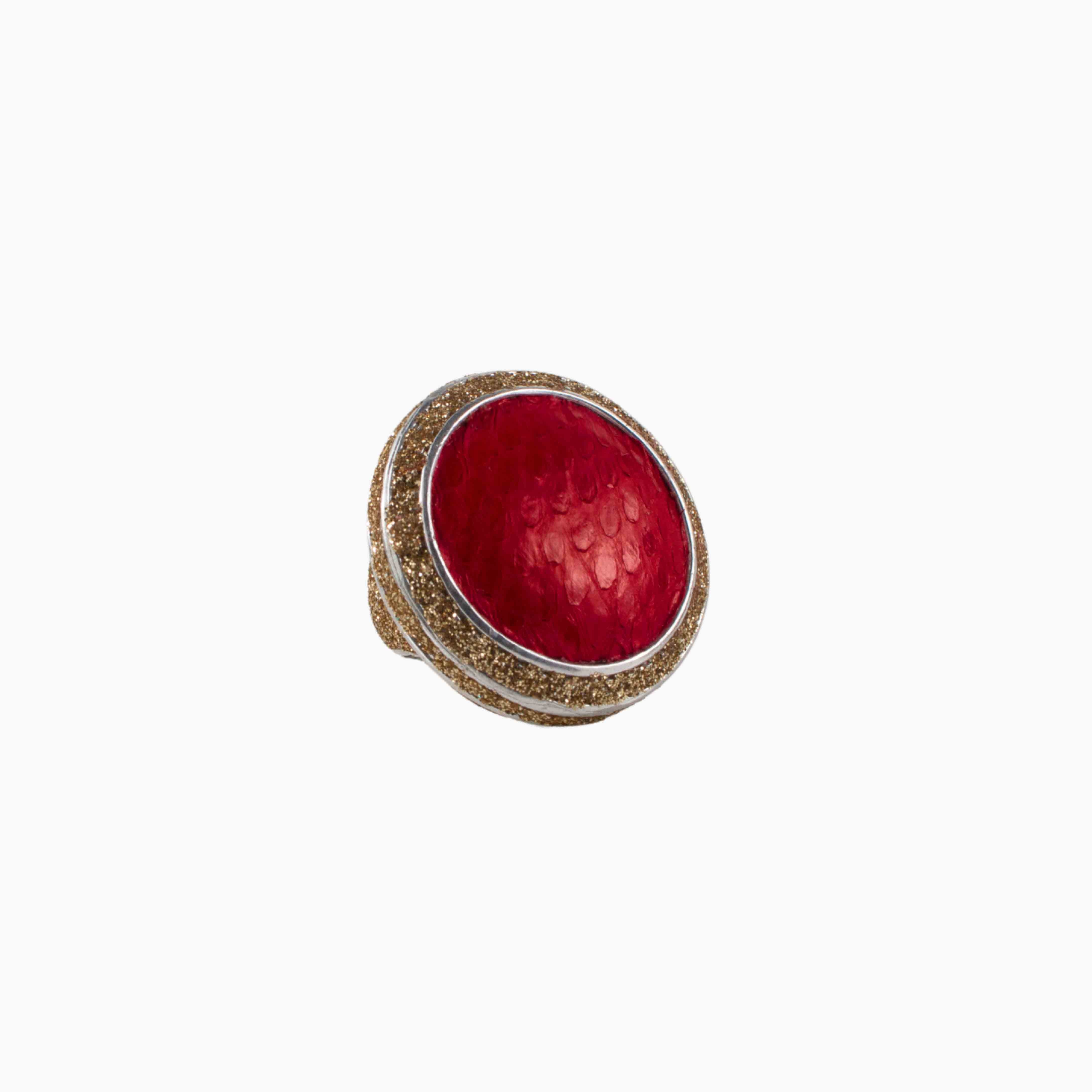 Ring with red color and gold band on a white background