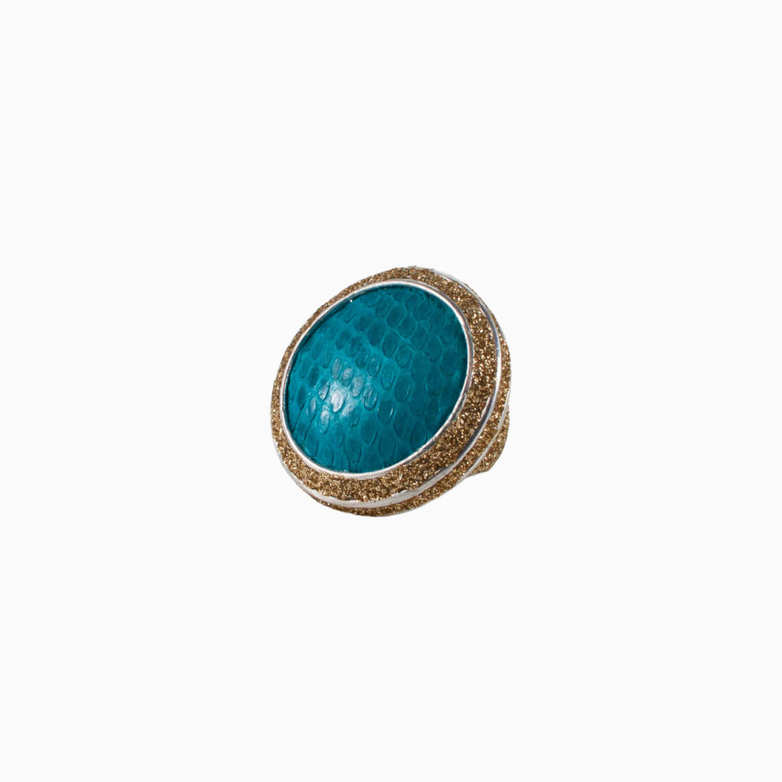 Ring with blue gemstone and gold accents on a white background