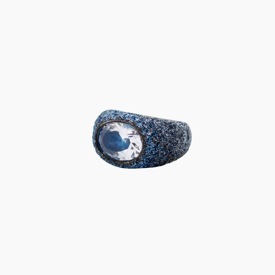 Ring with pink gemstone and gold accents on a white background