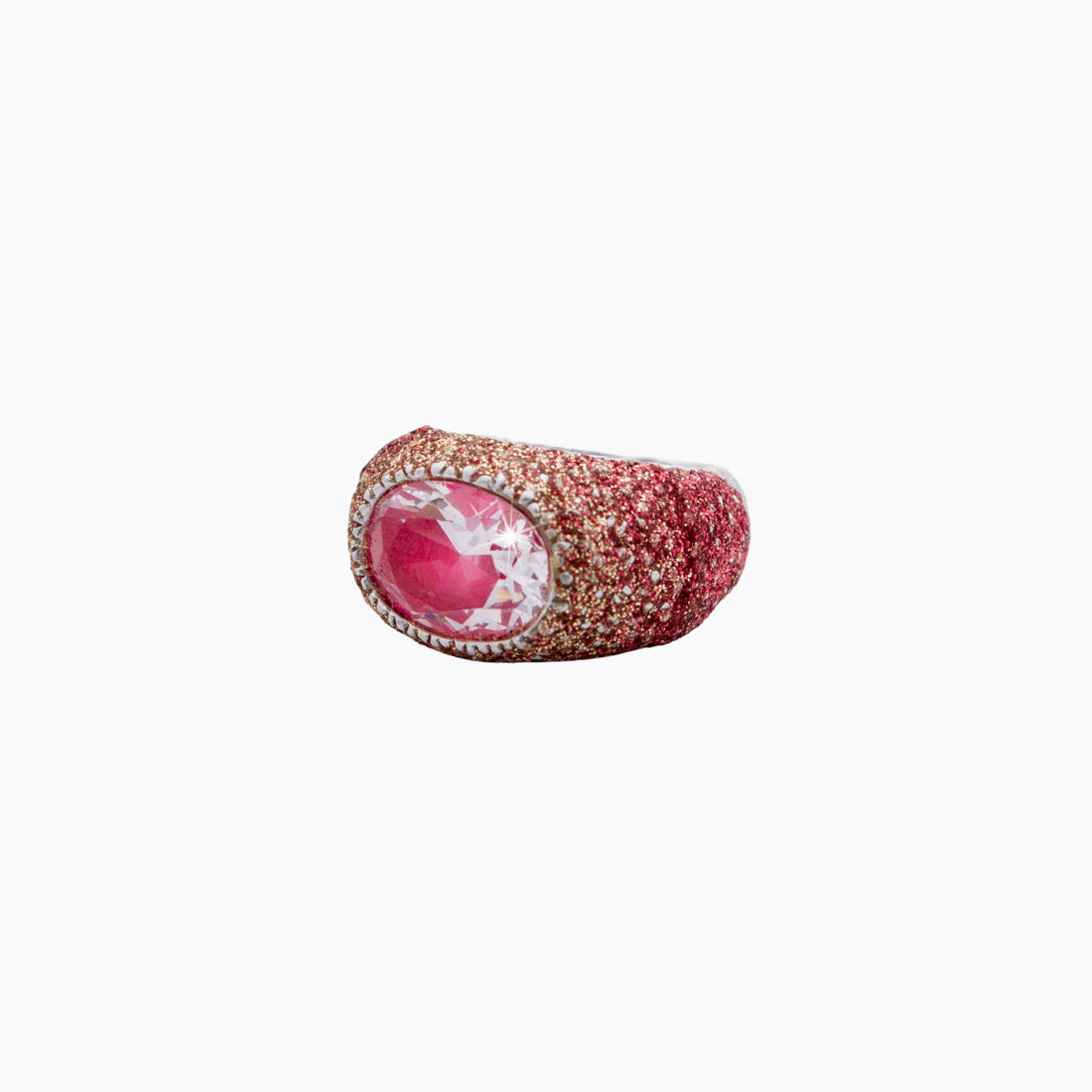 Ring with pink gemstone and gold accents on a white background