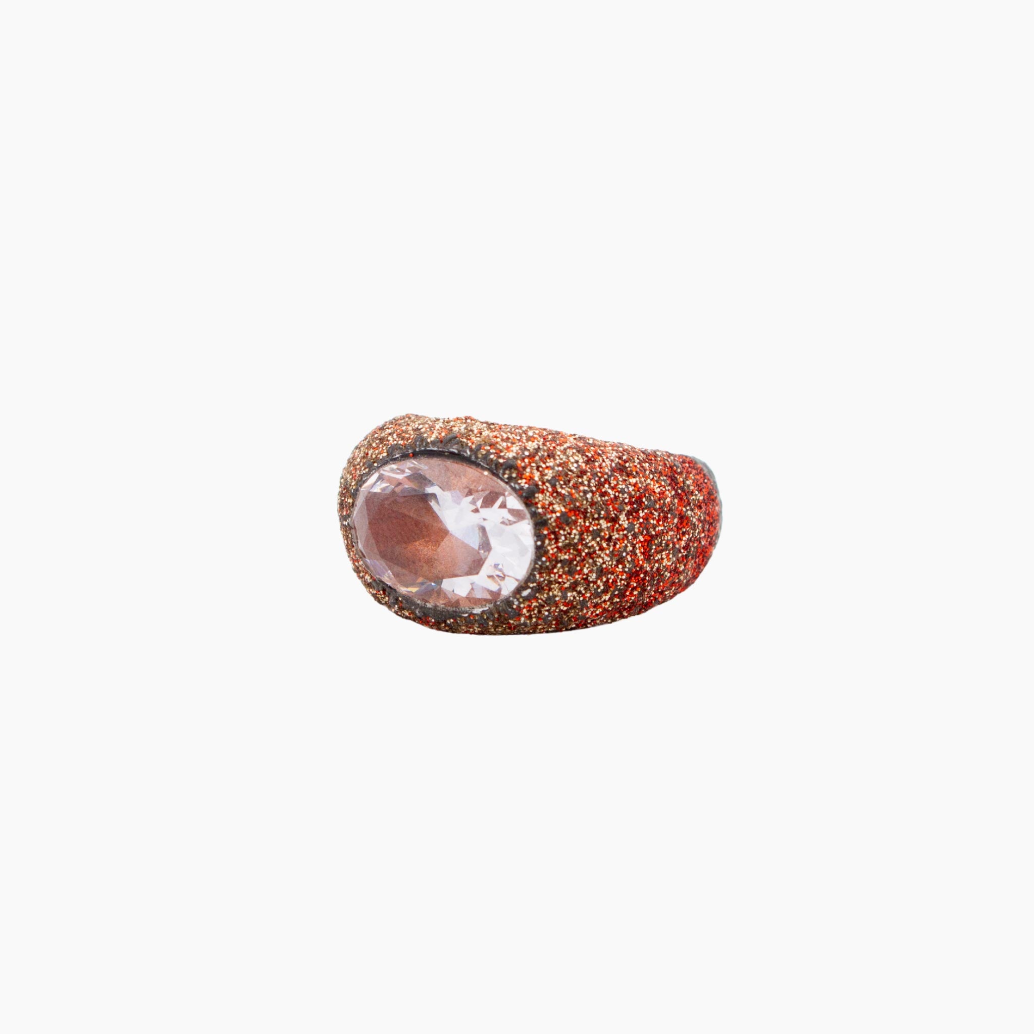 Ring with glittery and clear gemstone on a white background
