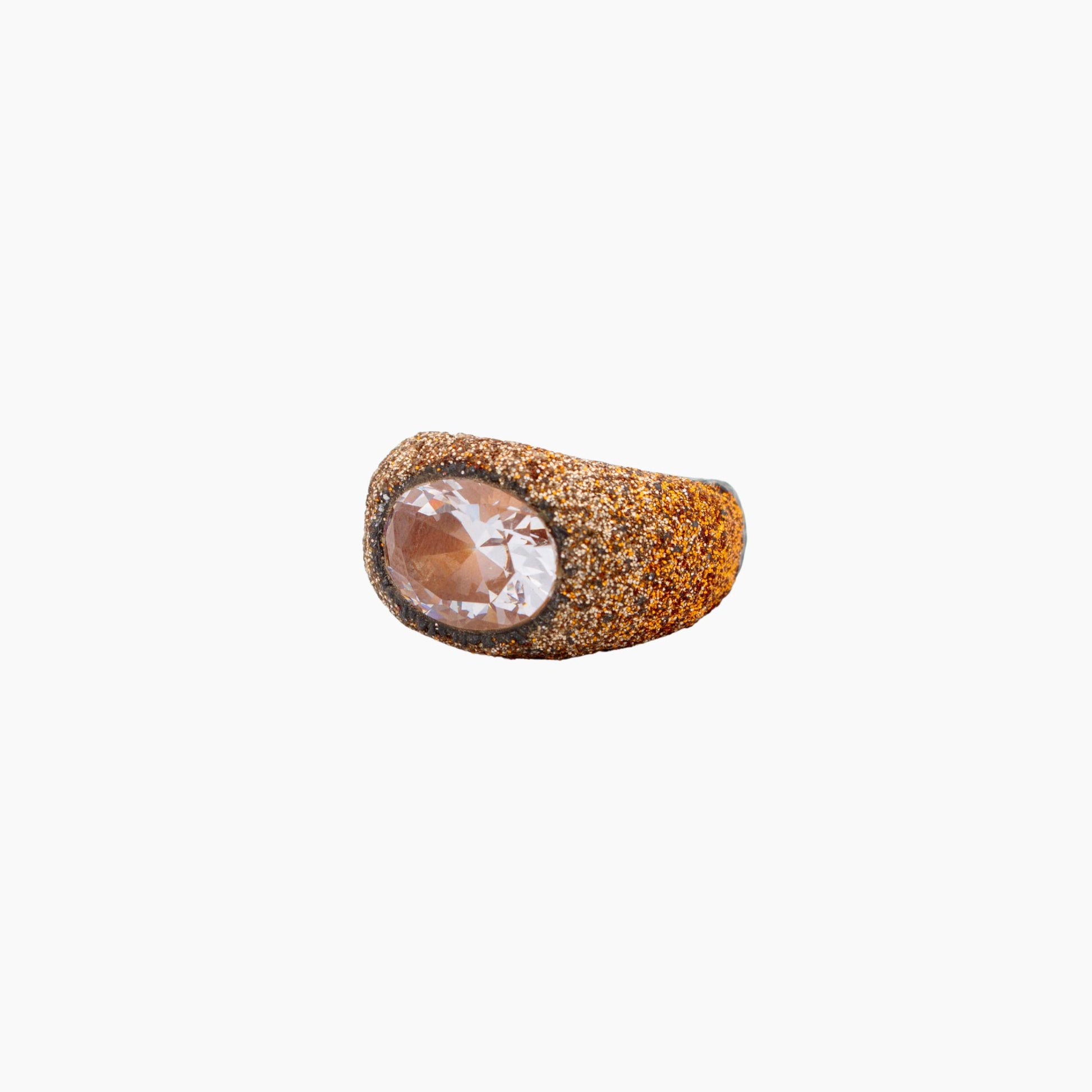 Ring with a textured and clear gemstone on a white background