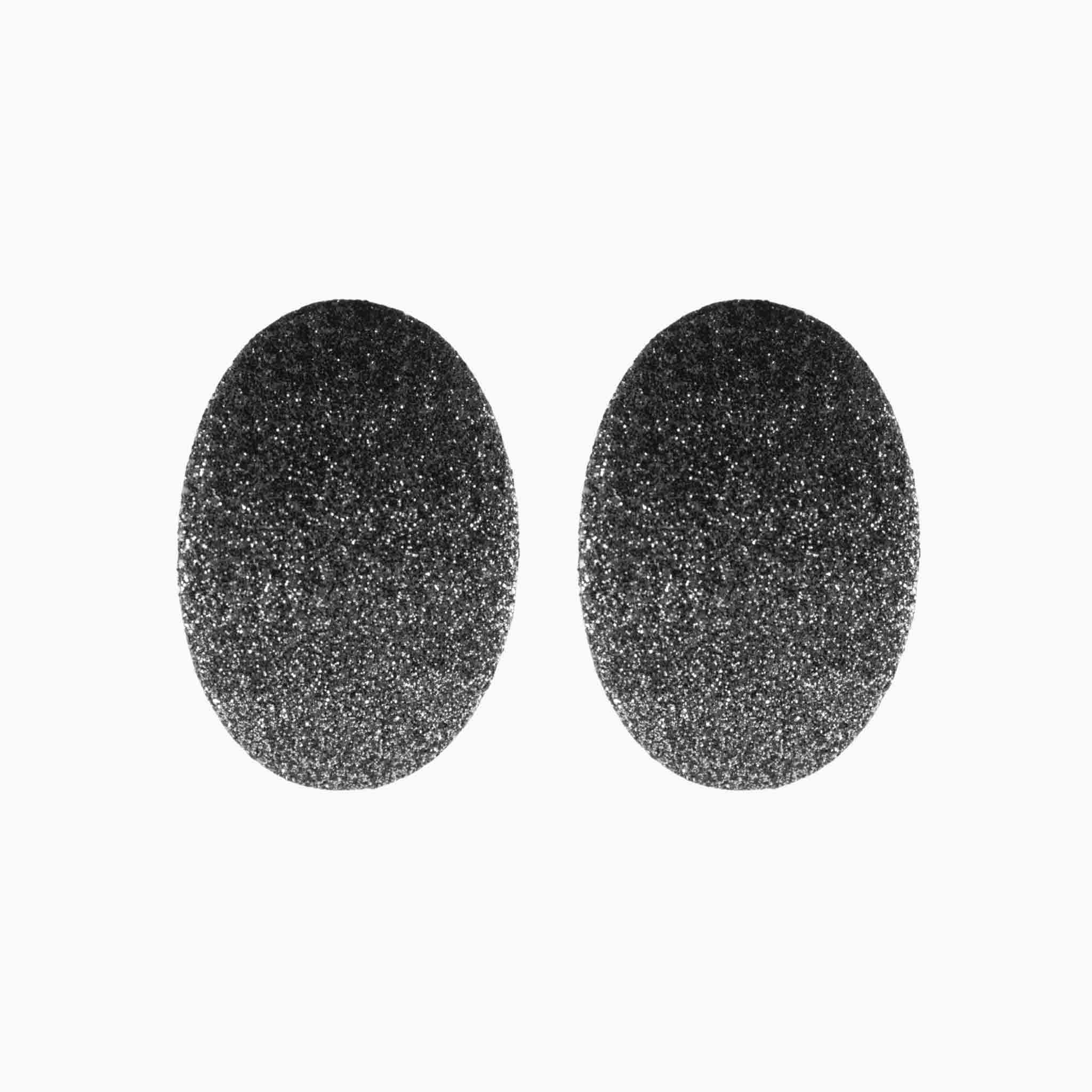 Two black oval earrings on a white background