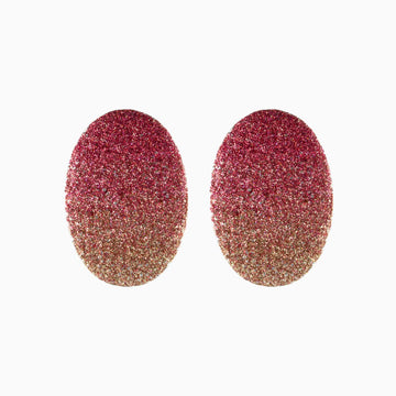 Pair of glittery pink and gold earrings on a white background