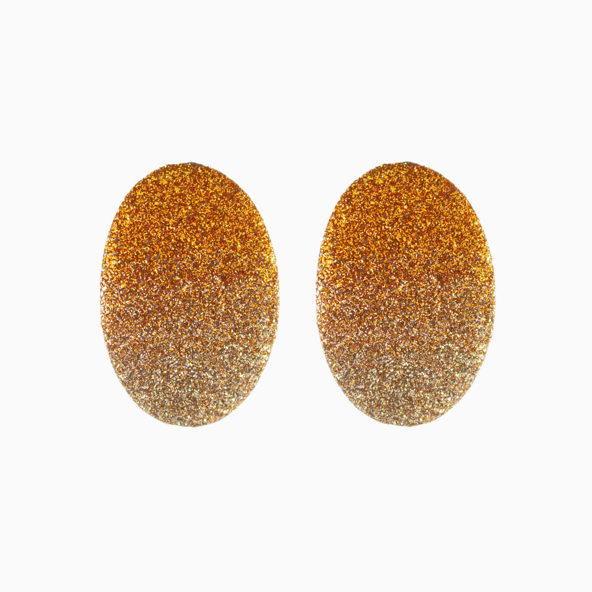 Pair of gold glittery oval earrings on a white background