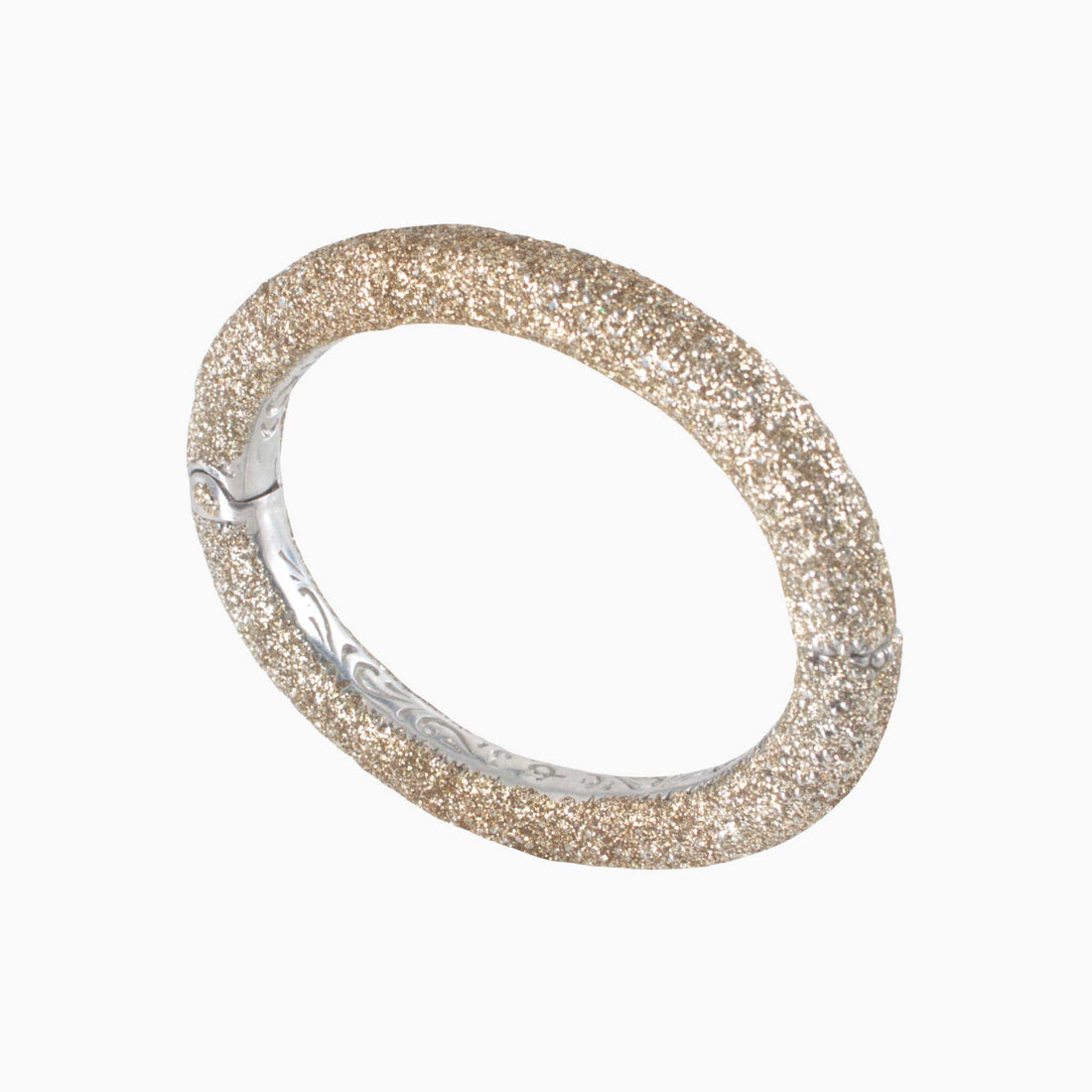 Silver bracelet with glittery band on a white background