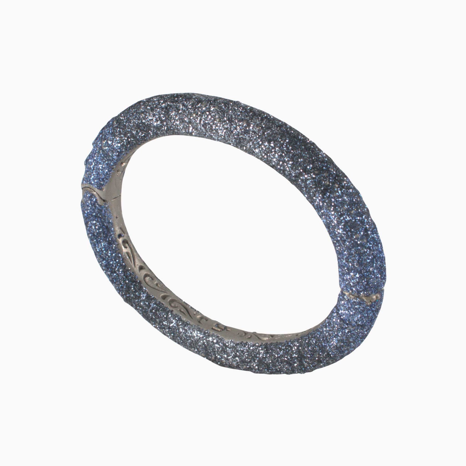 Silver bracelet with glittery texture on a white background