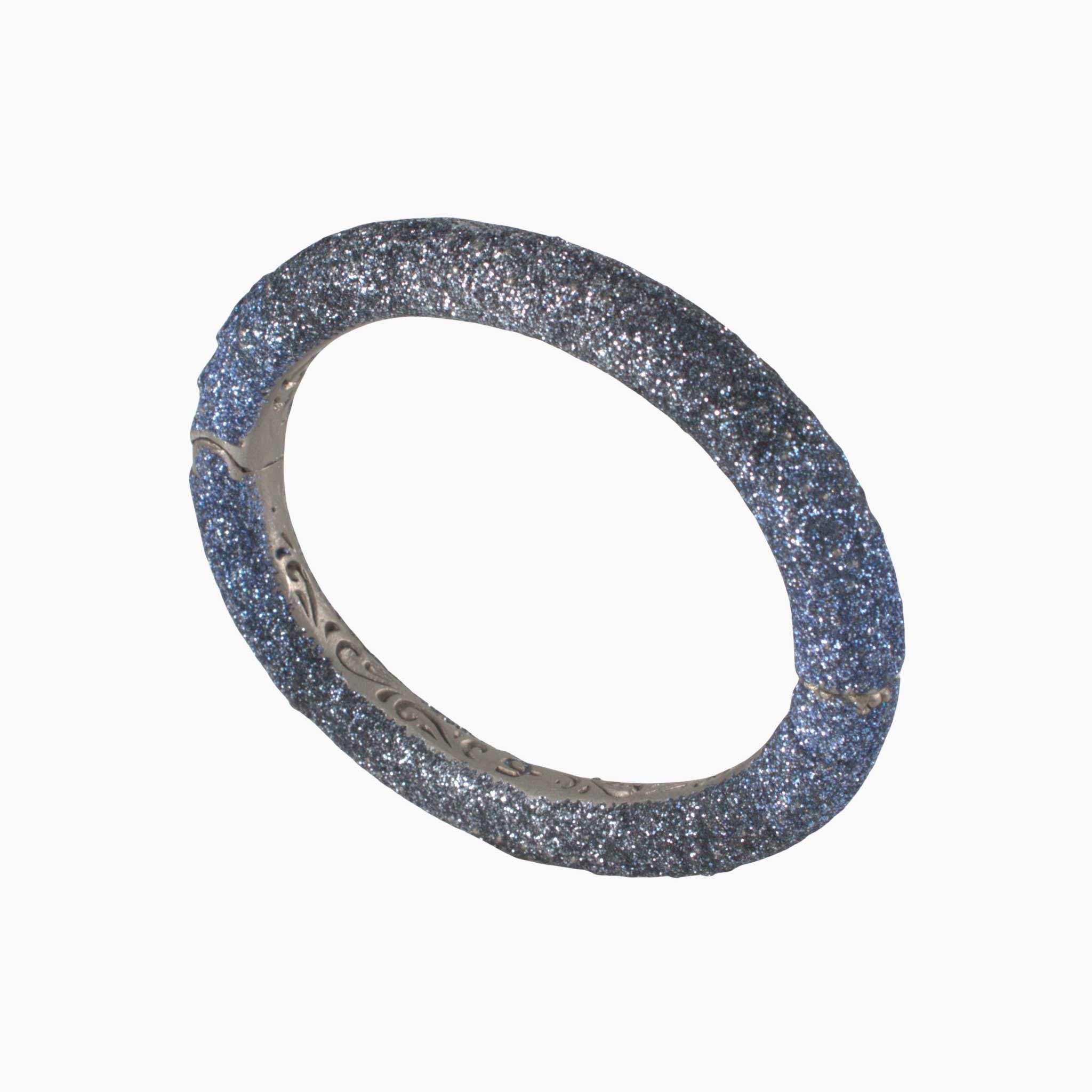 Silver bracelet with glittery texture on a white background