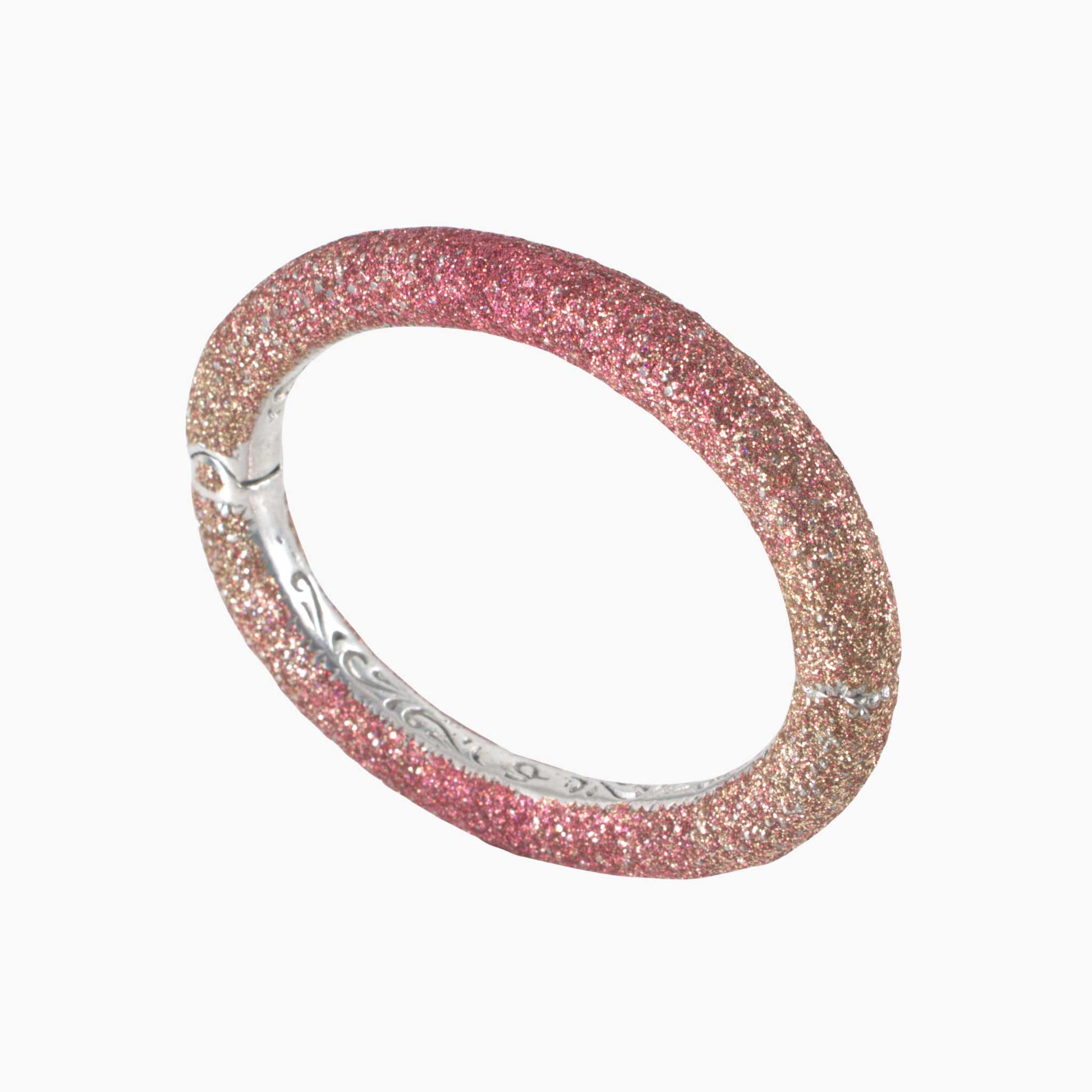 Pink glittery bracelet with silver band on a white background