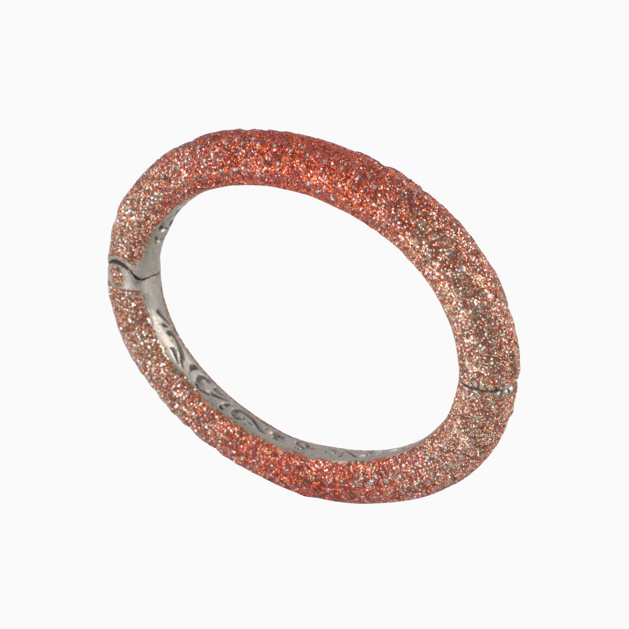 Rose gold bracelet with glittery texture on a white background