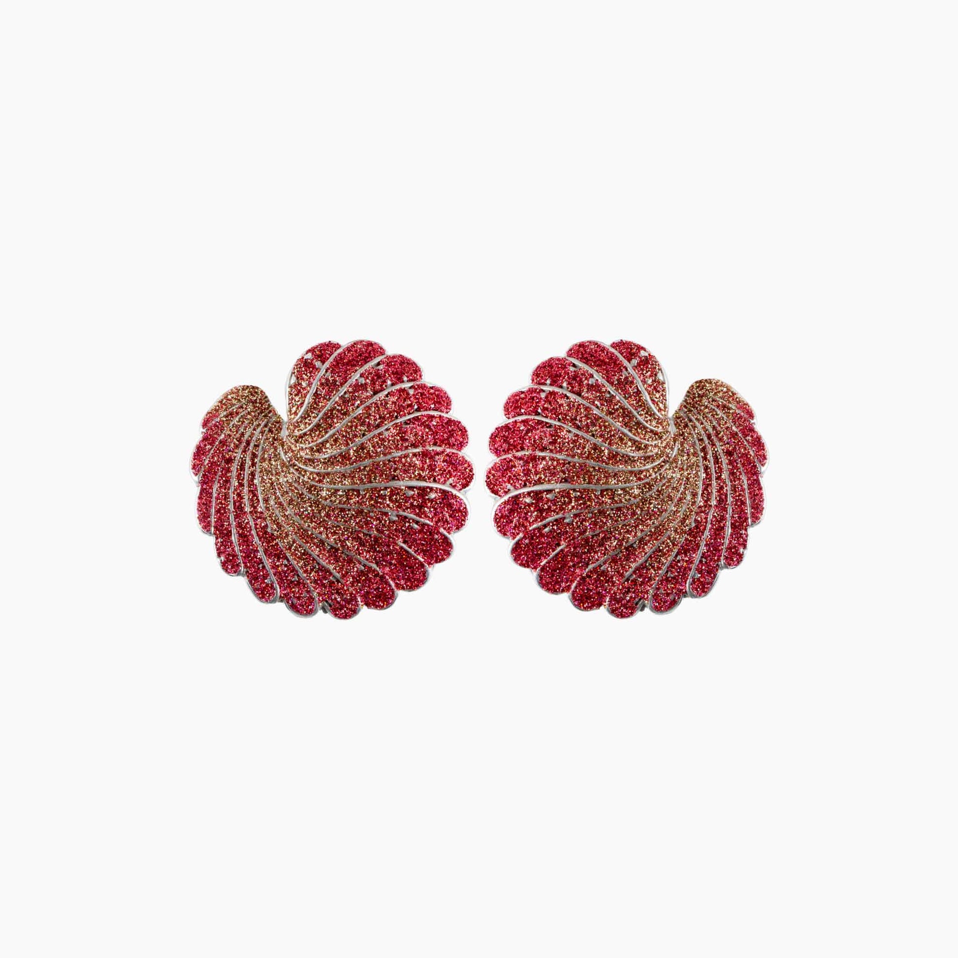 Pair of red and gold earrings on a white background