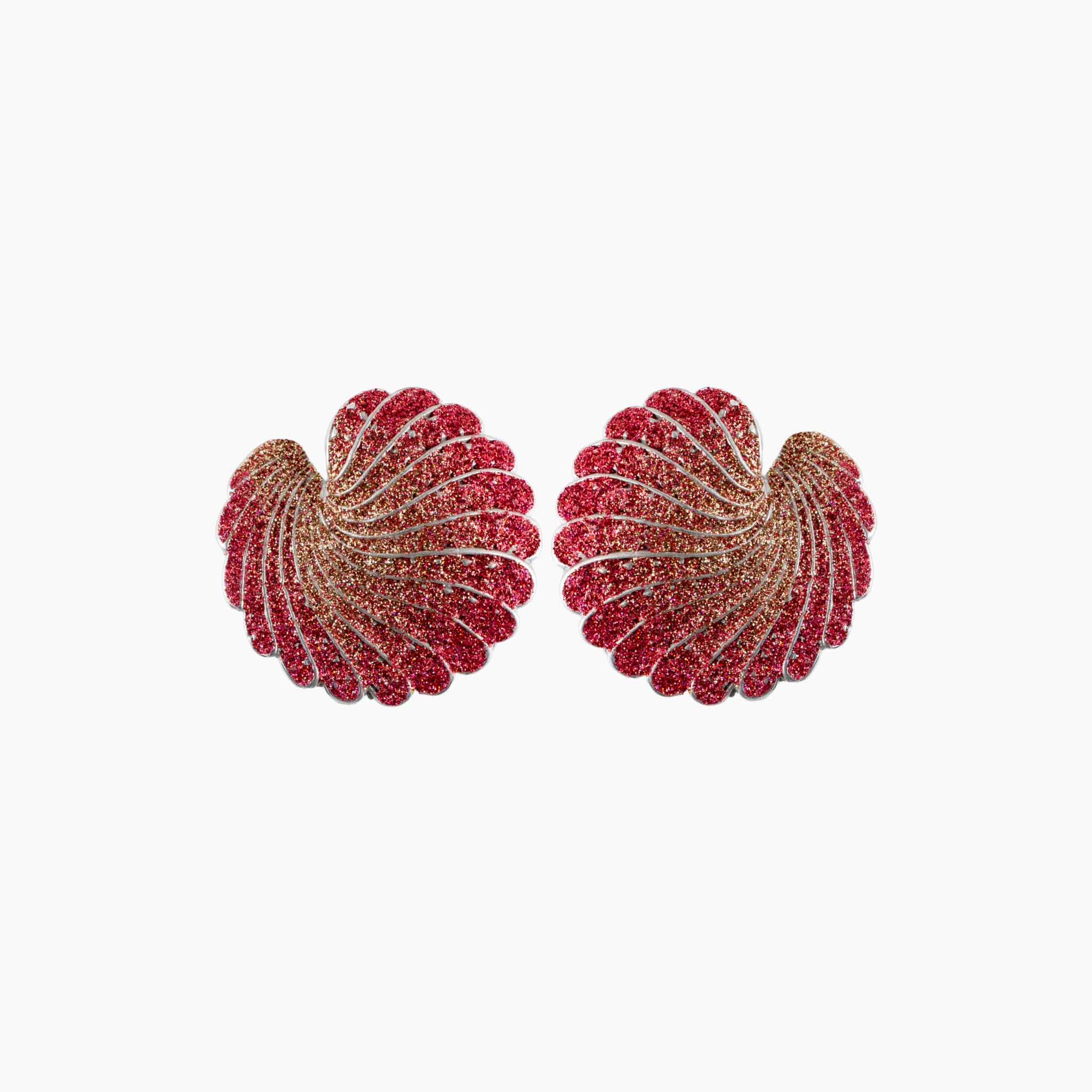 Pair of red and gold earrings on a white background