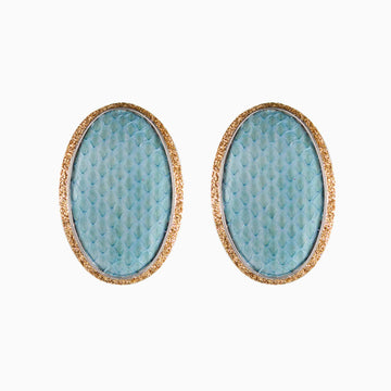Pair of earrings with blue textured centers and gold borders on a white background