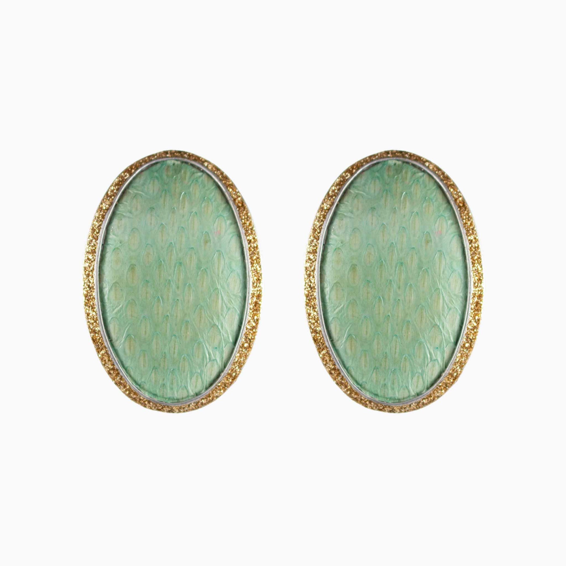 Pair of green oval earrings with gold accents on a white background