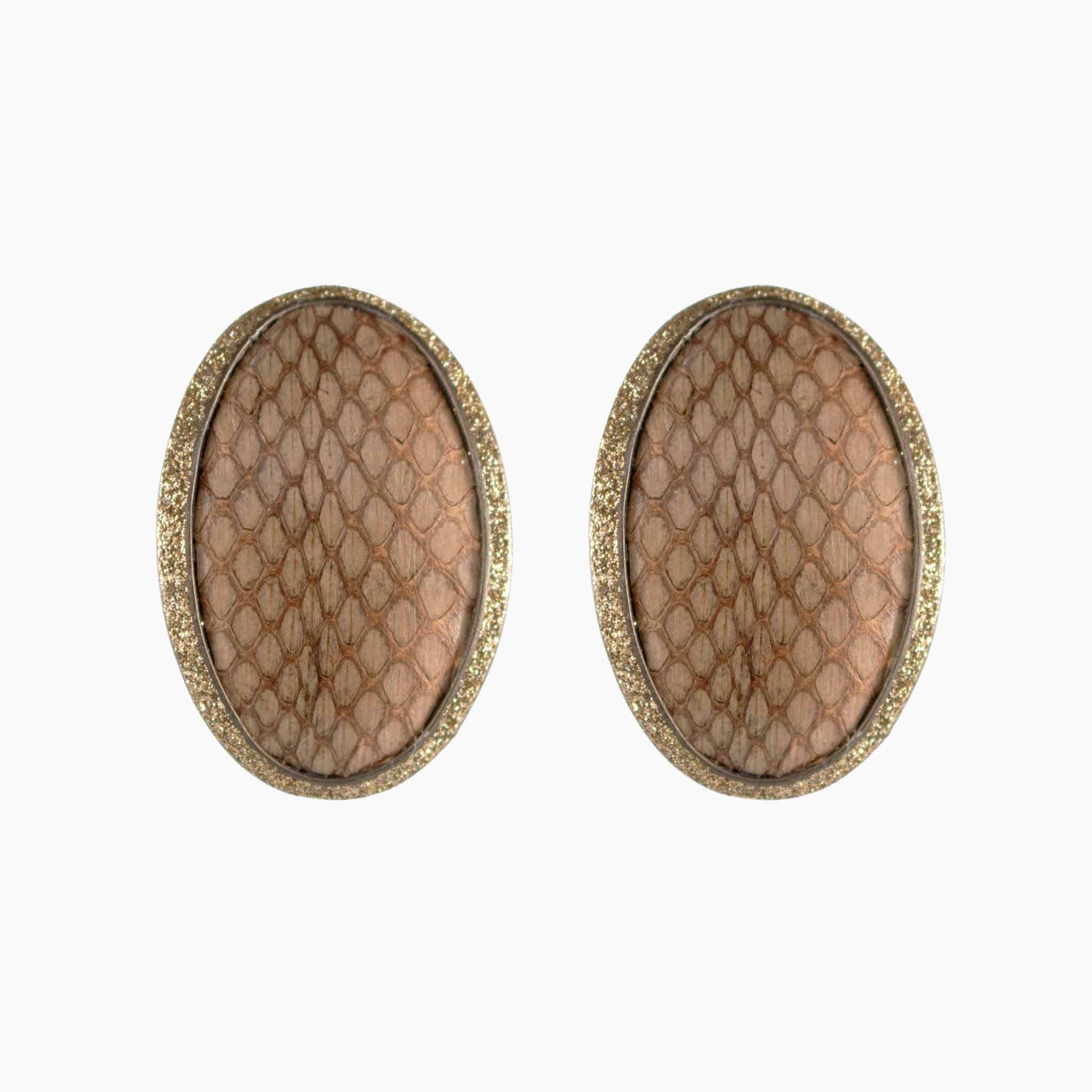 Pair of oval-shaped earrings with textured surface and gold border on a white background