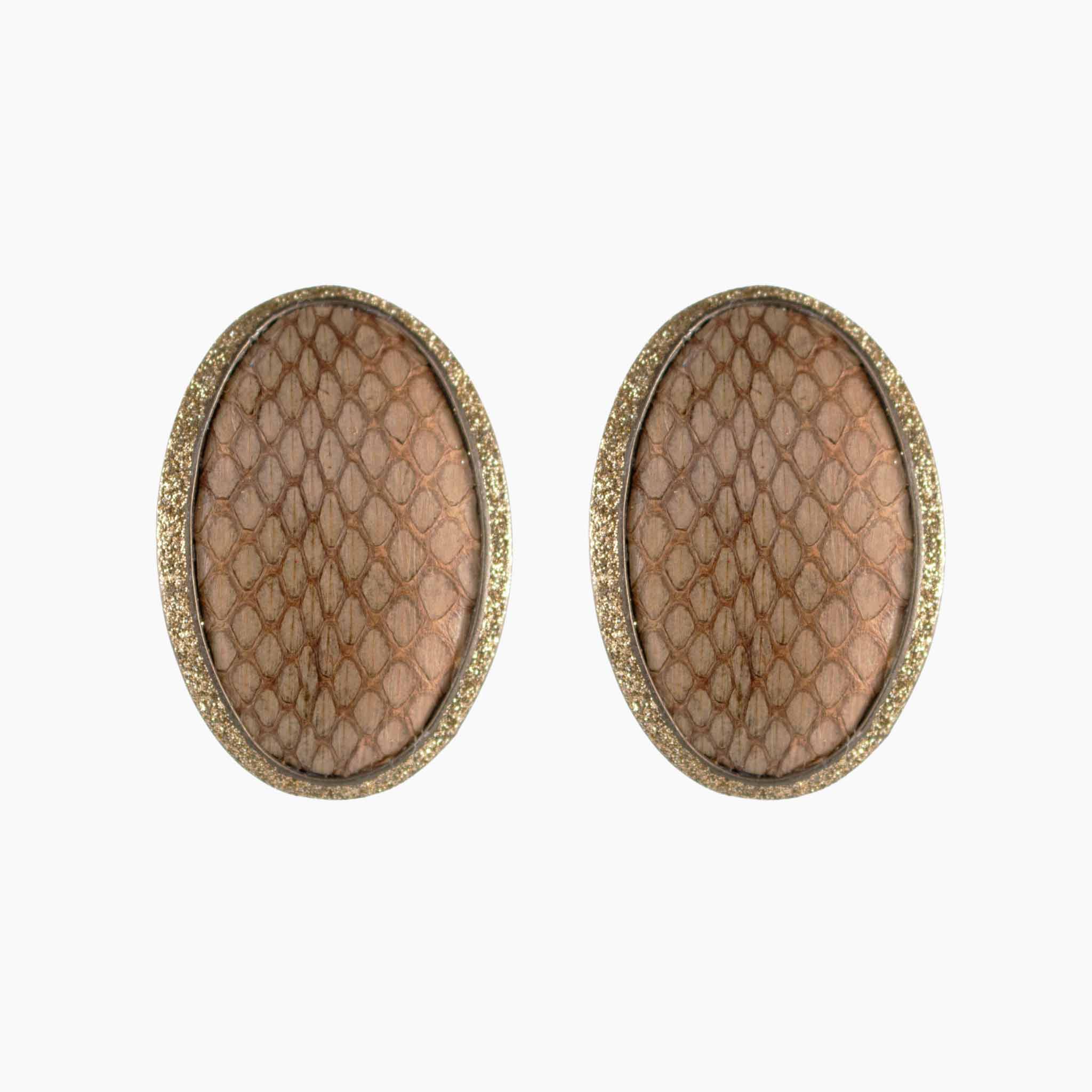 Pair of oval-shaped earrings with textured surface and gold border on a white background