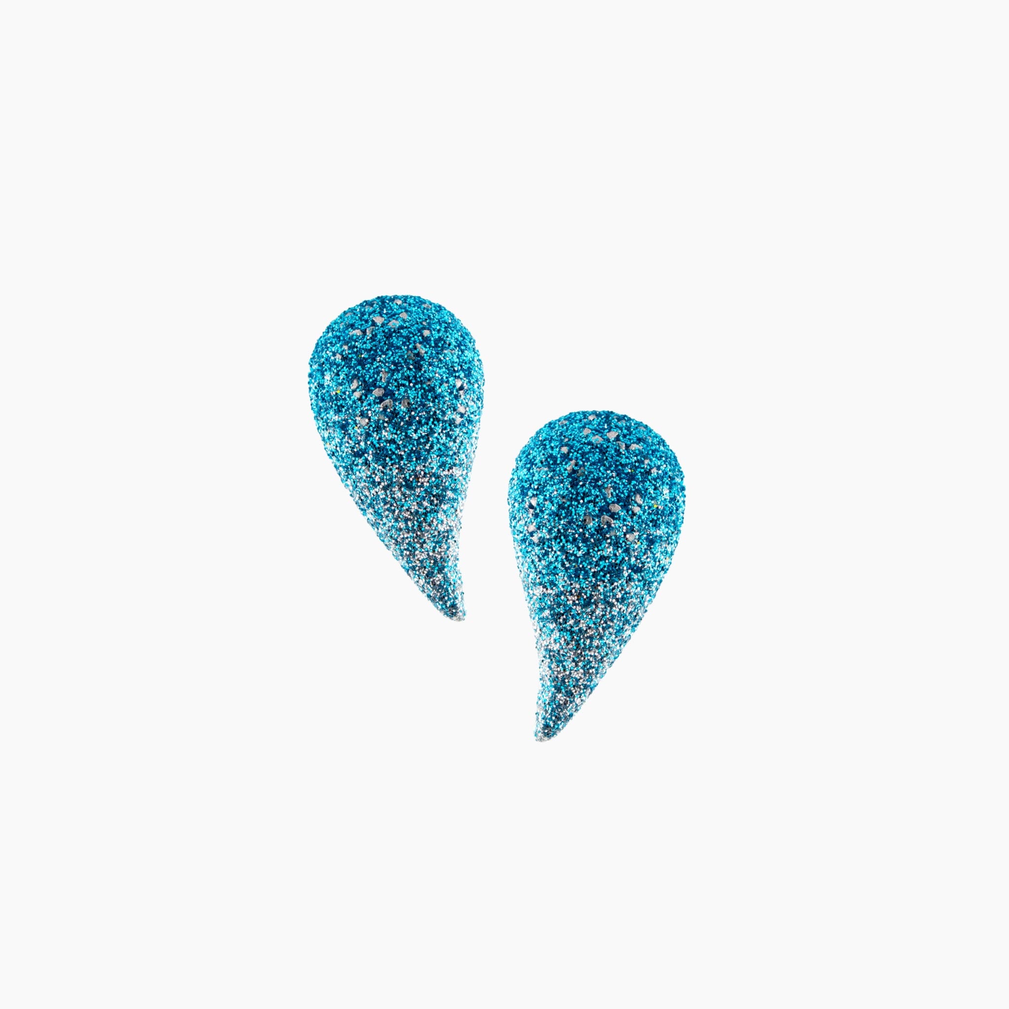 Blue glittery teardrop-shaped earrings on a white background