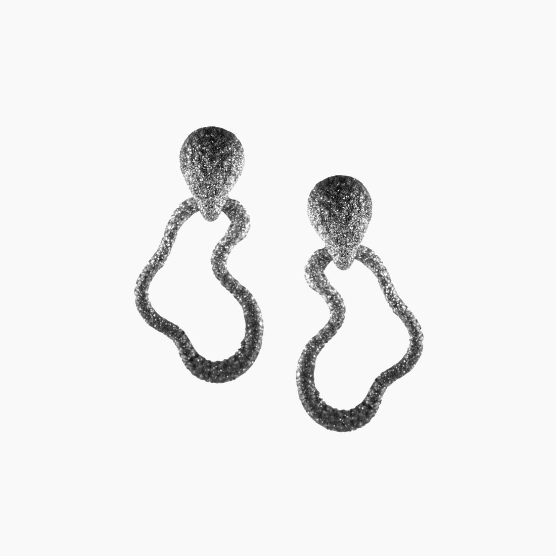 Pair of earrings with textured design on a white background