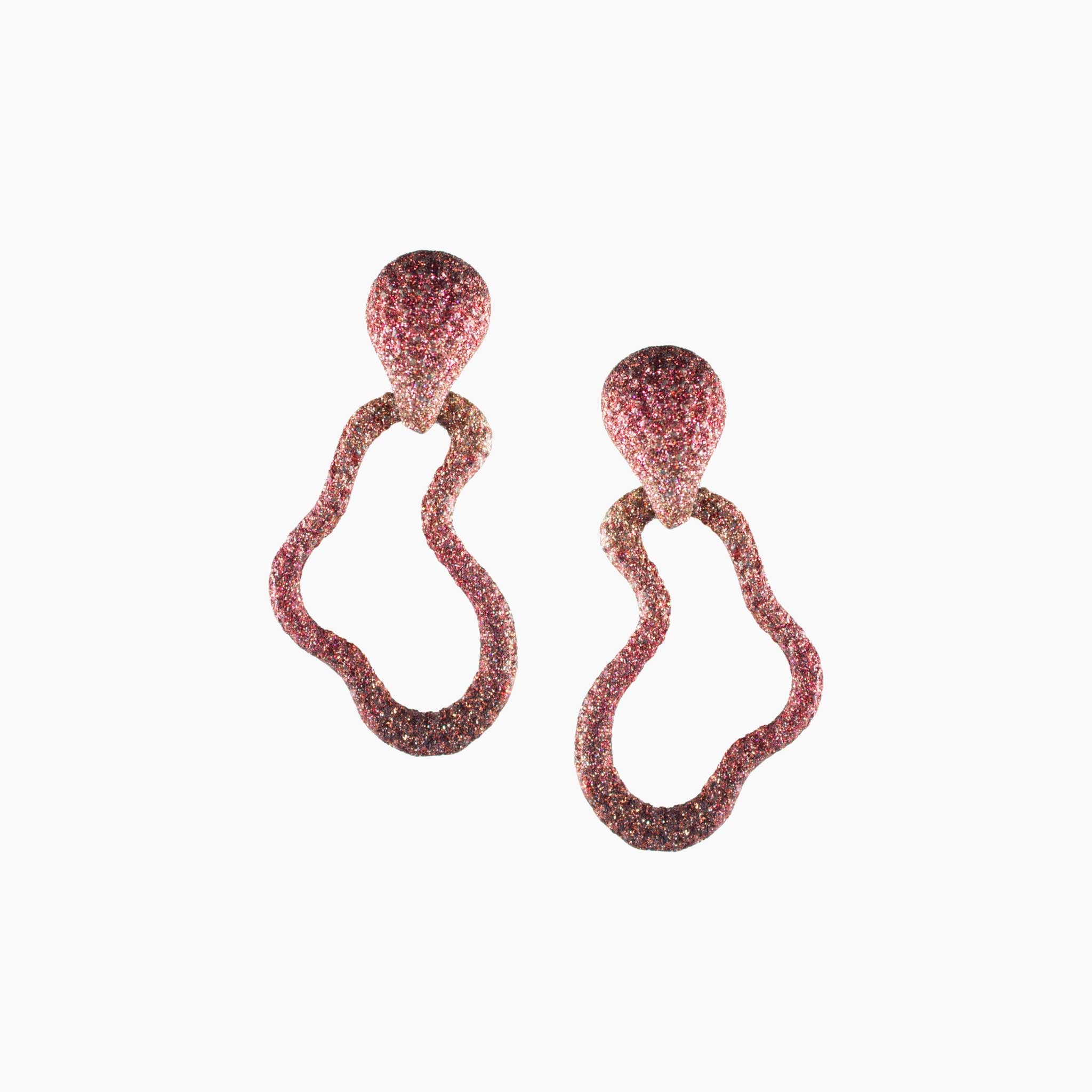 Pair of pink glittery earrings on a white background
