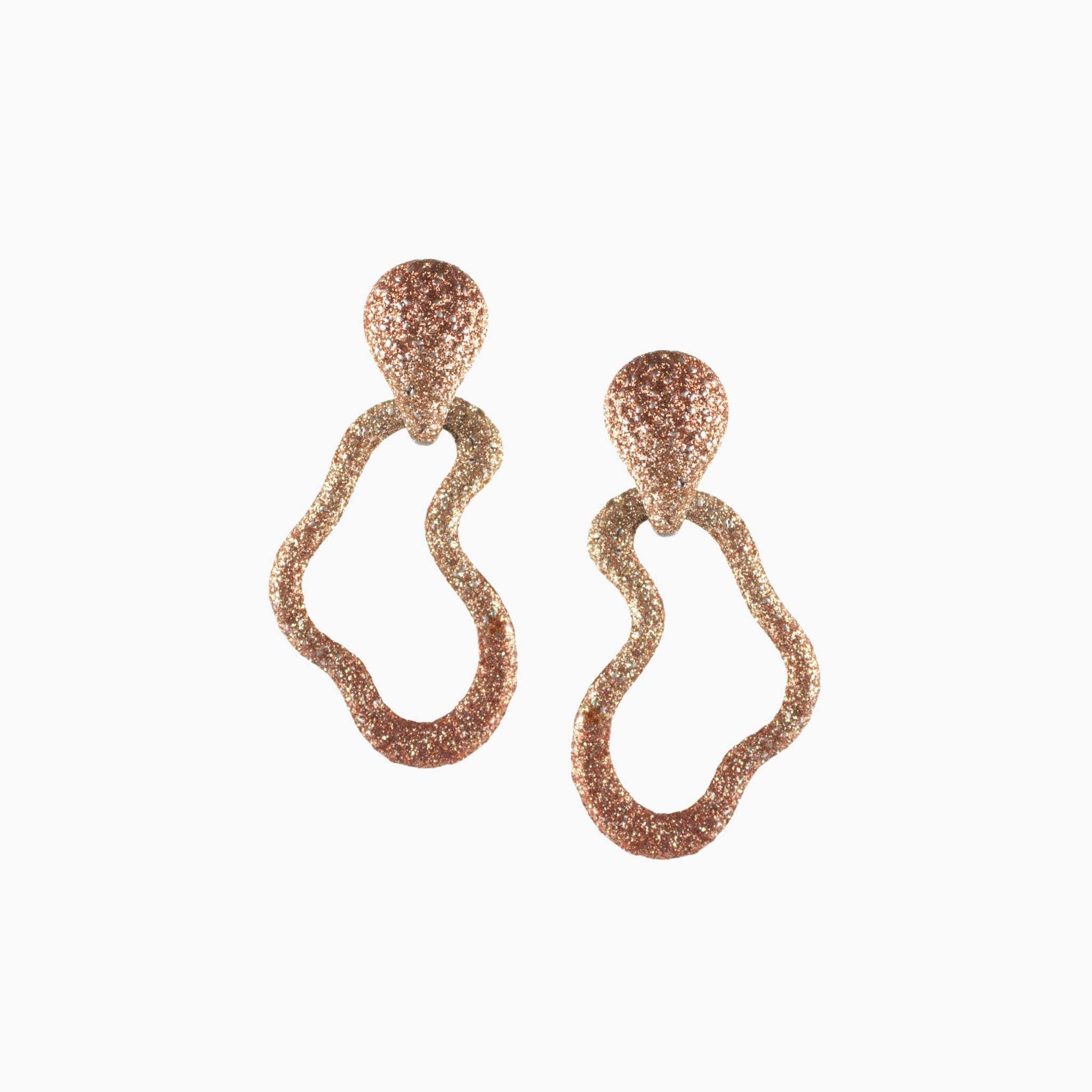 Pair of rose gold earrings on a white background
