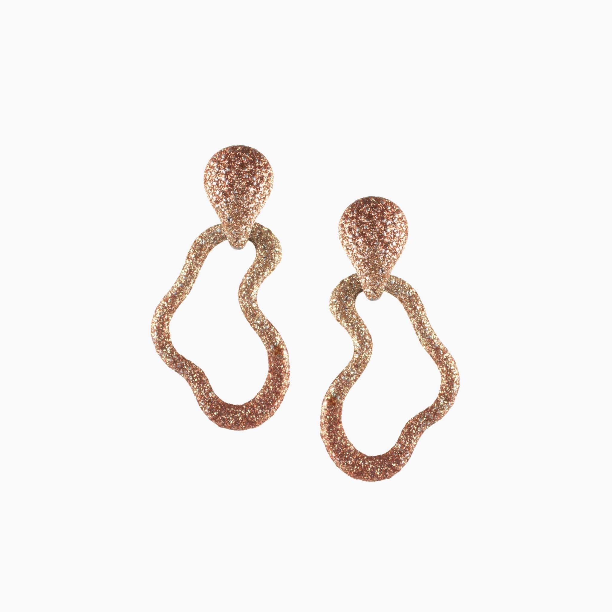 Pair of rose gold earrings on a white background
