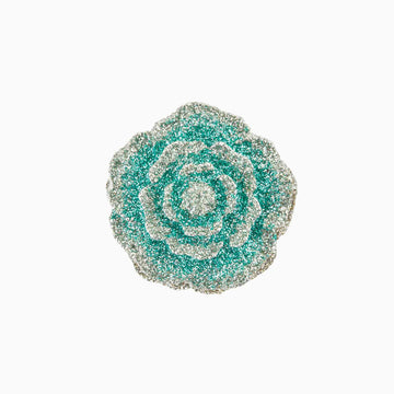 Decorative brooch with a floral design on a white background